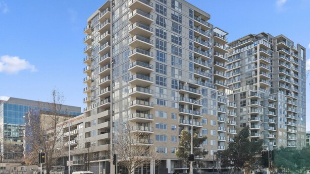 A high-rise residential building with multiple balconies, large windows, and a modern architectural design. - Central Lakeview Apartments (Canberra)