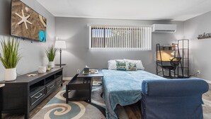 A modern bedroom with a bed, desk, chair, and a small balcony area. - Spacious2BR/Work Crews & Families/Sleeps6/desk/Parking/WIFI/Pet friendly (Aurora)