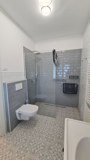 Shower, hair dryer, towels, toilet paper