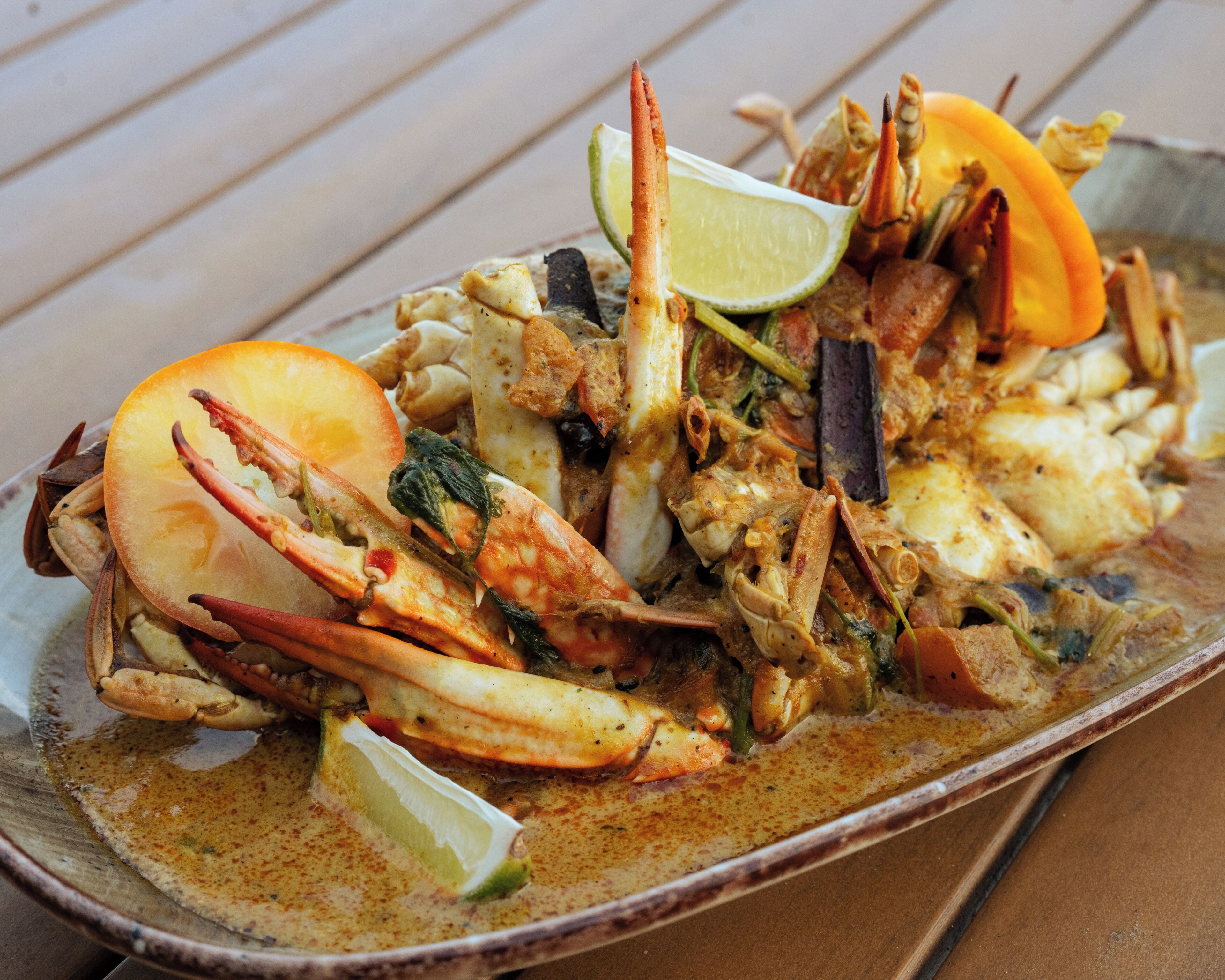 A seafood dish with various ingredients and garnishes.