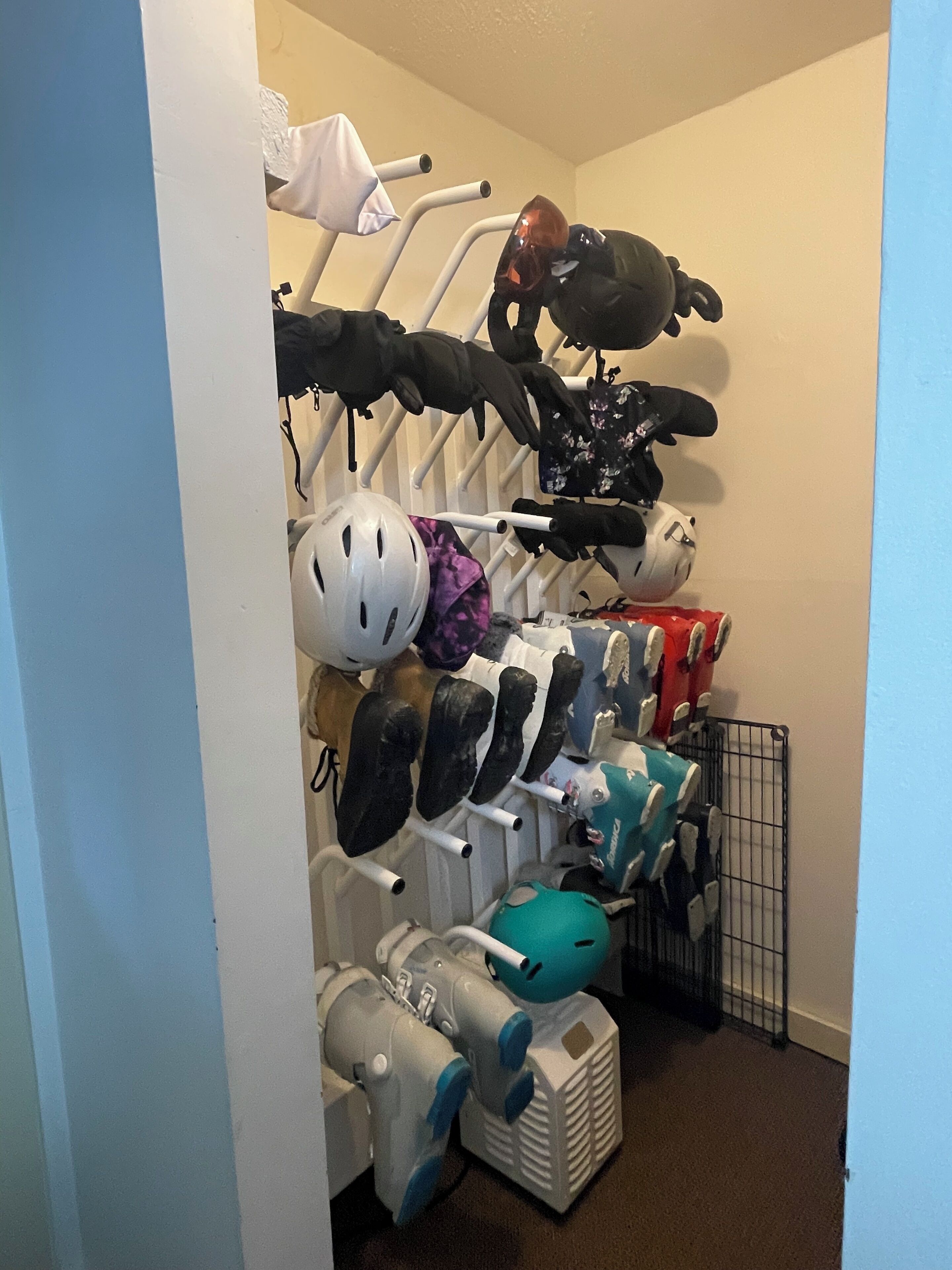 A storage rack with helmets, goggles, and protective gear.