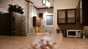 A kitchen with a refrigerator, microwave, and cabinets. - AL Mansour Mohammed, very sunny،Amazing terrace (Zamalek)