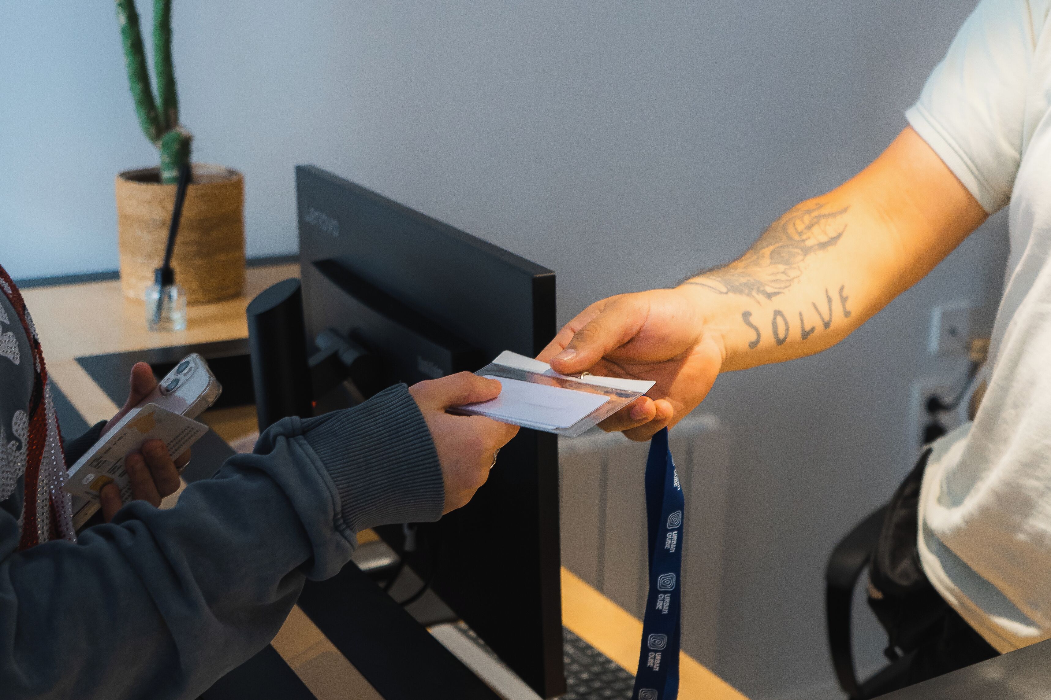 A person handing over a card to another person.