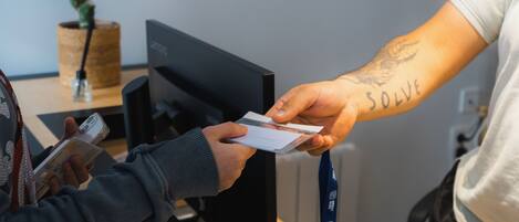 A person handing over a card to another person.
