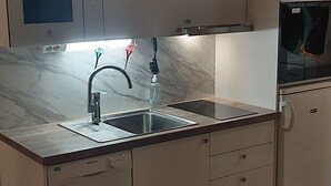 A modern kitchen with a built-in microwave, oven, and dishwasher.
