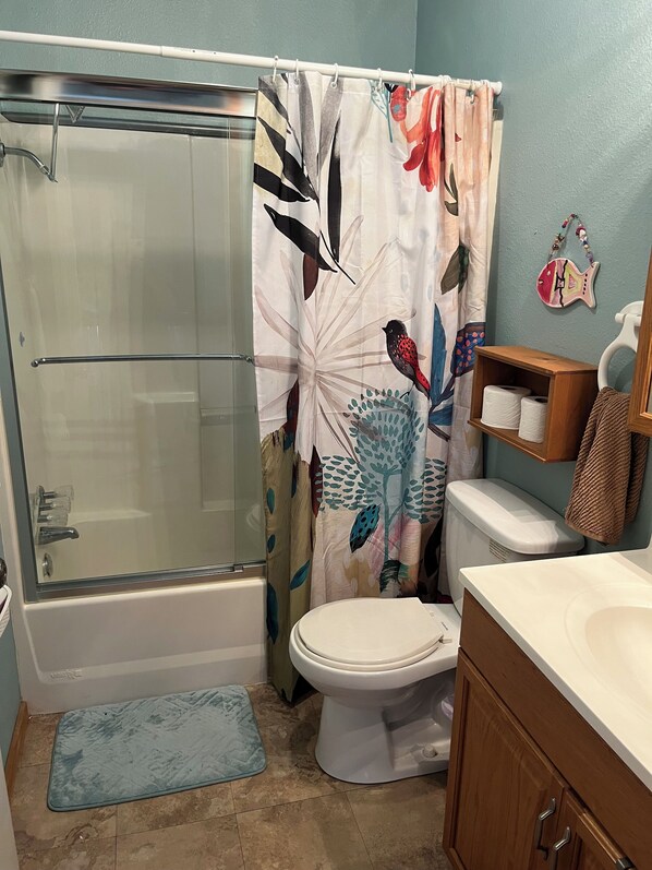 A bathroom with a glass-enclosed shower, a toilet, and a sink. - Quiet Waterfront camp15 minutes from Bay St. Louis. EXCELLENT family Reunions! (Pearlington)