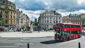A red double-decker bus labeled 'Blackwall 15' on a city street.