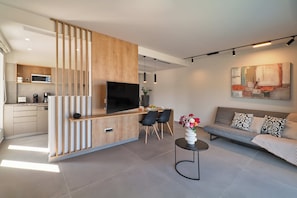 A modern living space with a kitchen, dining area, and seating area.