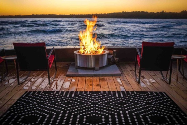 Unwind by the fire as waves crash and the sky burns gold — lakeside nights don’t get better than this.