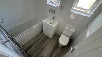 Combined shower/bathtub, deep-soaking bathtub, towels