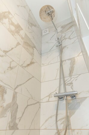 Shower, hair dryer, towels, toilet paper