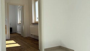A staircase leading to a room with a radiator and a window.