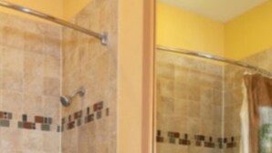 A bathroom with a bathtub, toilet, and wooden vanity. - Unique, River Ranch & Rodeo, Fl  2 Cabins, Nov_Dec Enjoy Exhilarating Activities (River Ranch)