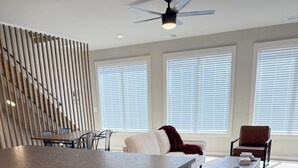 A modern kitchen with a central island, wooden cabinets, and a ceiling fan. - 18 Miles to Clemson & 13 Miles to Greenville 2 Bd 2.5 Bath Bourbon Lovers Dream (Easley)