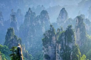 A mountainous landscape with tall rock formations and dense greenery. - Fenglinge Hotel (Zhangjiajie)