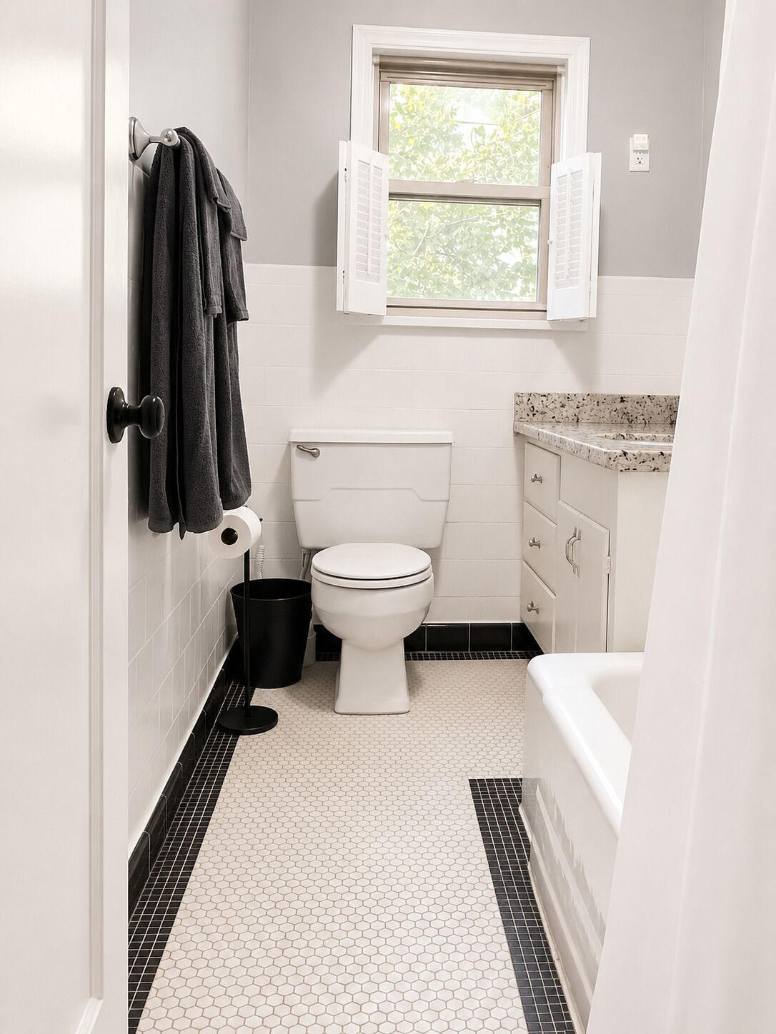 A bathroom with a toilet, a sink, a window, and a towel rack.