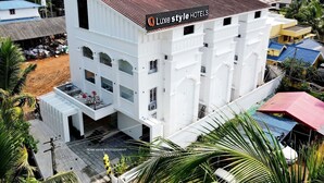 A multi-story building with a sign reading "Luxury Style Hotels". - LUXESTYLE (Adoor)