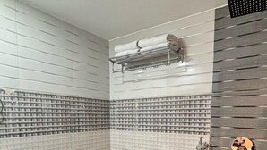 A bathroom with a toilet, sink, and towel rack. - LUXESTYLE (Adoor)