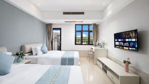 A hotel room with two beds, a desk, a TV, and a window with a view. - Sanya Xintai Ocean View Hotel (Sanya)
