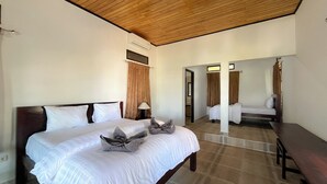 A hotel room with a large bed, a wooden ceiling, and a bathroom visible through an open door. - Bara Cabana Hotel (Bira)