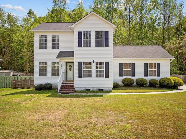 A two-story house with a front porch, a mailbox, and a number 137 on the door.