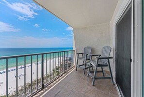 Un balcon avec vue sur une plage et l’océan.