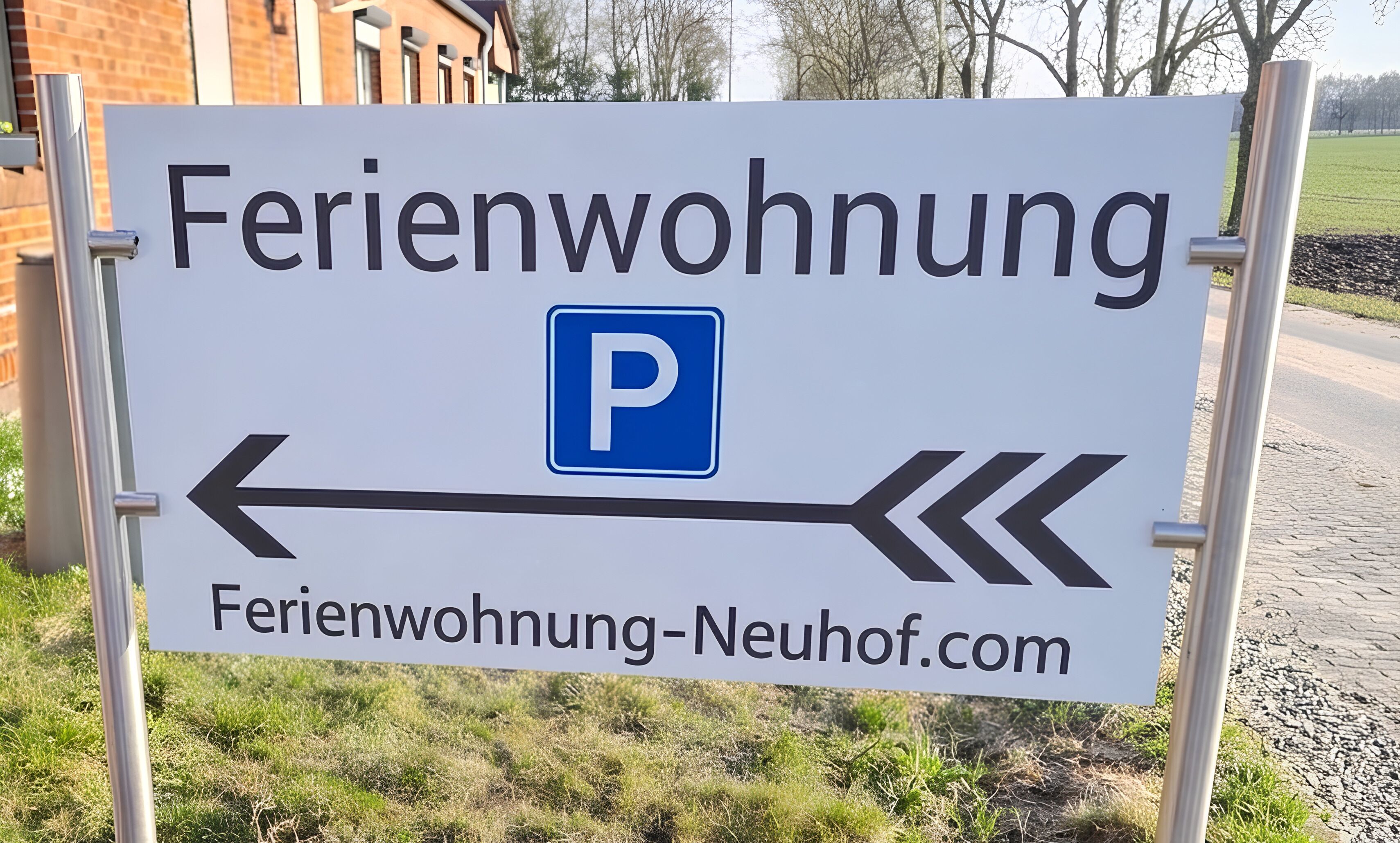 A sign for a parking area with arrows pointing left and right, and a website address below.