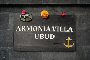 A wooden sign with the text "ARMONIVILLA UBUD" and an anchor symbol. - Armonia Private Villa Ubud (Ubud)
