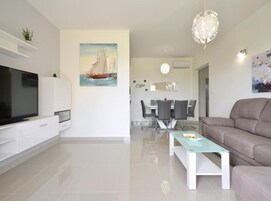 Apartment (Three Bedroom Apartment with Balcony) | Living room | 32-inch flat-screen TV with satellite channels