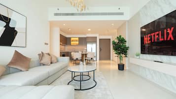 Deluxe Apartment, Sea View | Living area | 125-cm flat-screen TV with digital channels, Netflix, streaming services
