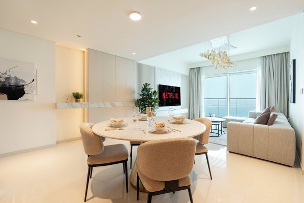 Deluxe Apartment, Sea View | Living area | 125-cm flat-screen TV with digital channels, Netflix, streaming services