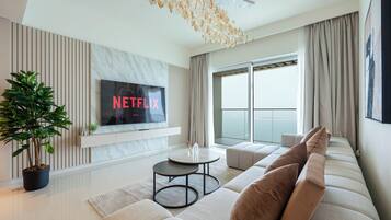 Deluxe Apartment, Sea View | Living area | 125-cm flat-screen TV with digital channels, Netflix, streaming services