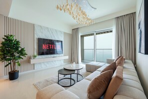 Deluxe Apartment, Sea View | Living area | 125-cm flat-screen TV with digital channels, Netflix, streaming services