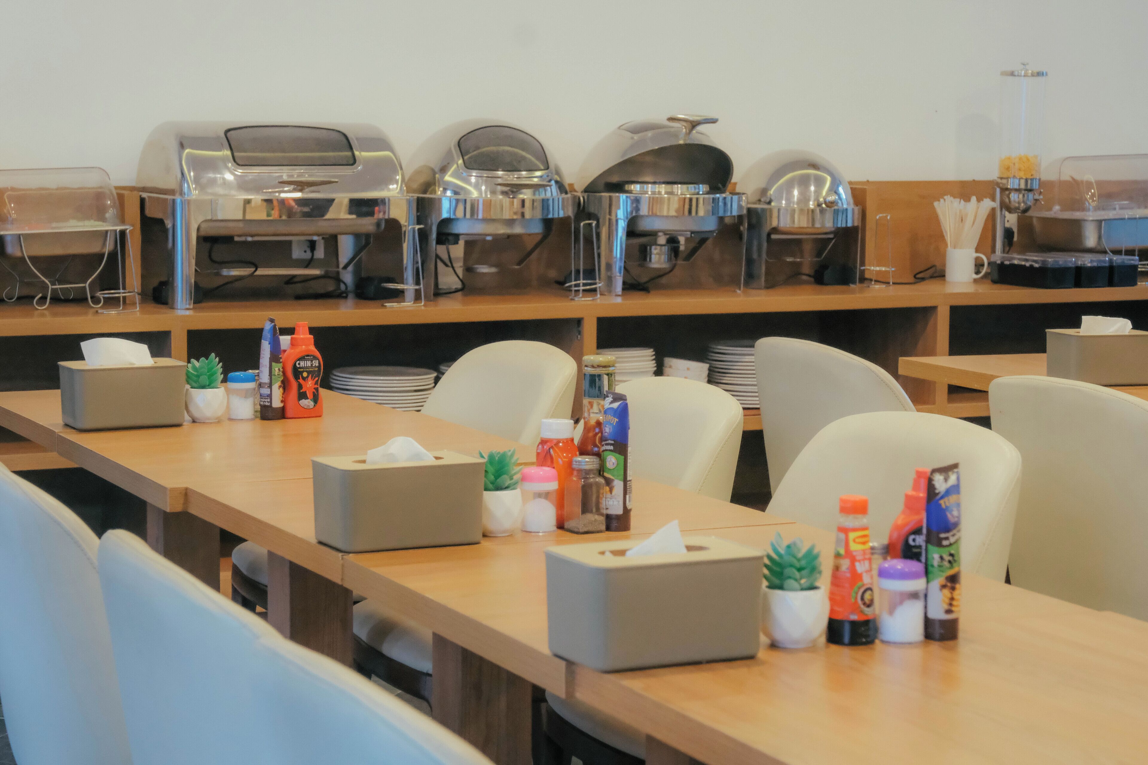 A buffet setup with various food stations and condiments.