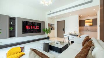 Deluxe Apartment, Balcony, Sea View | Living area | 90-cm flat-screen TV with digital channels, Netflix, streaming services
