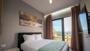 A bedroom with a bed, a nightstand, a painting, a window with curtains, and a view of the outdoors. - Dreamy Farm (Mesopotam)