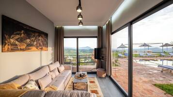 Deluxe Apartment, Balcony, Courtyard View | Living area | Flat-screen TV