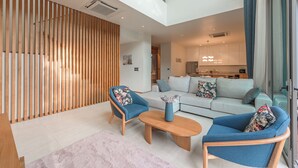 A modern living room with a sofa, two armchairs, and a coffee table. - Pool Villa Near Beach Boat Avenue V219 (Choeng Thale)