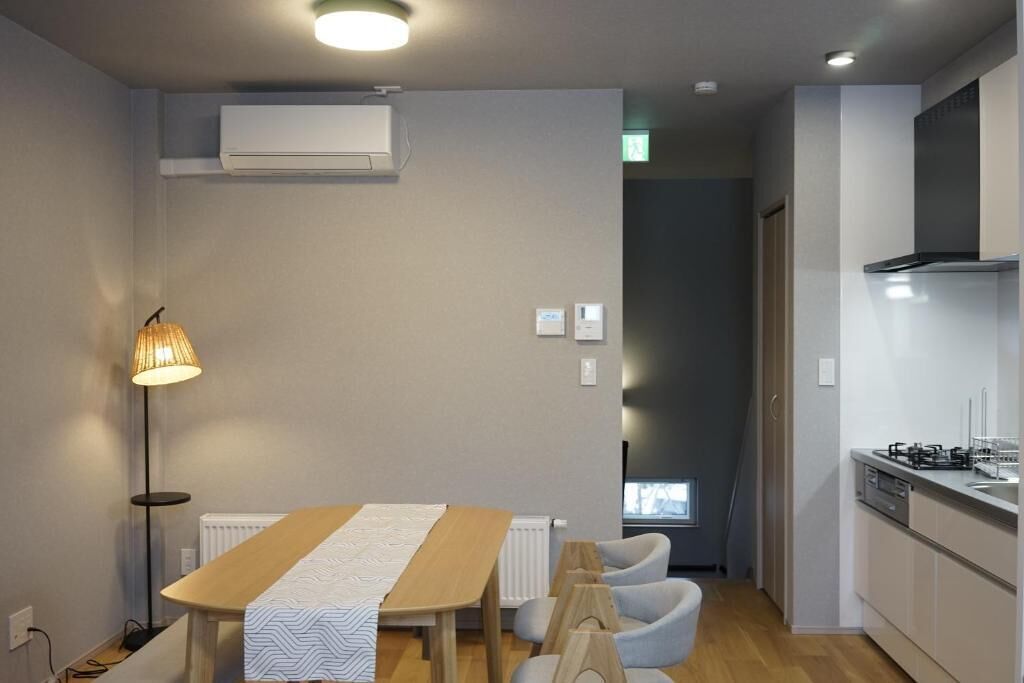 A modern kitchen with white cabinets, a built-in stove, and a window.