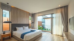 A modern bedroom with a large bed, wooden headboard, and a view of a balcony. - Near Beach & Famous Boat Ave V217 (Choeng Thale)