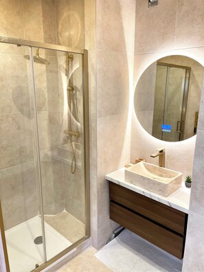 Shower, hair dryer, towels, toilet paper