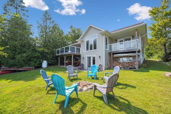 Gather around the firepit for cozy evenings under the stars, with stunning views of the lake and the warm glow of your private retreat behind you.