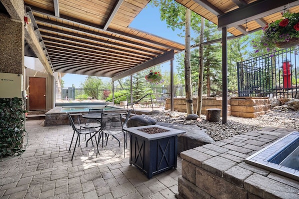 An outdoor patio with a pool table, seating, and a fire pit. - Ski In/Ski Out 2BR Condo, Dog Friendly, Hot Tubs at Beaver Run (Breckenridge)