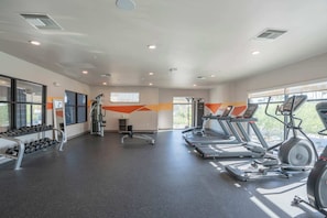 A gym with treadmills, dumbbells, and weight machines. - Tempe DT Escape | Pool, Gym, W/D, Parking Sleeps 4 (Tempe)