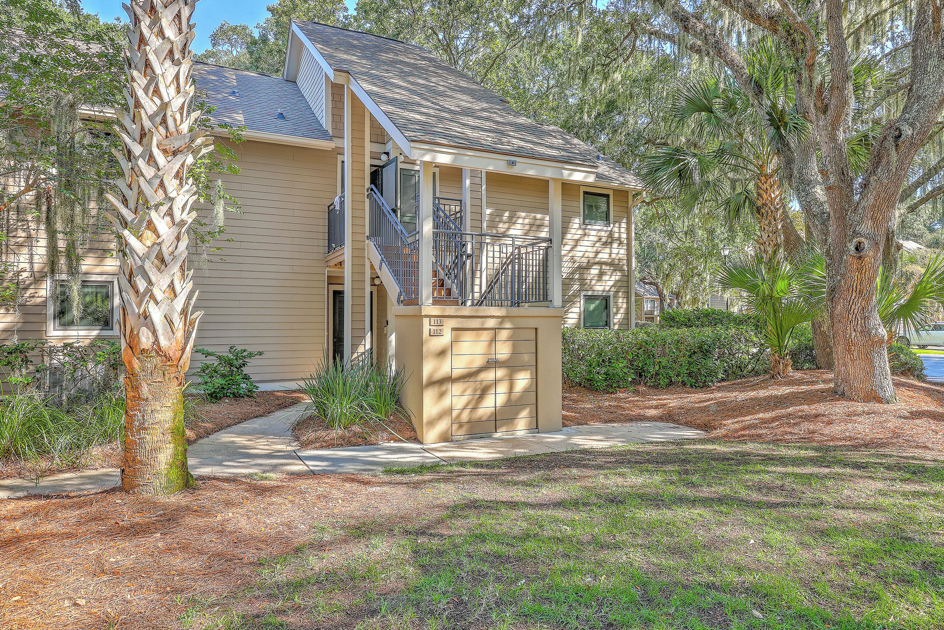 A two-story house with a covered porch, a visible staircase, and a garage.