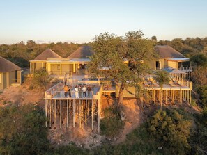 A resort with multiple buildings, a central tree, and a wooden deck. - Klaserie Drift Amani (Klaserie Private Nature Reserve)