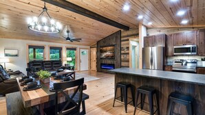 A spacious kitchen with wooden cabinets, a large island, and modern appliances.