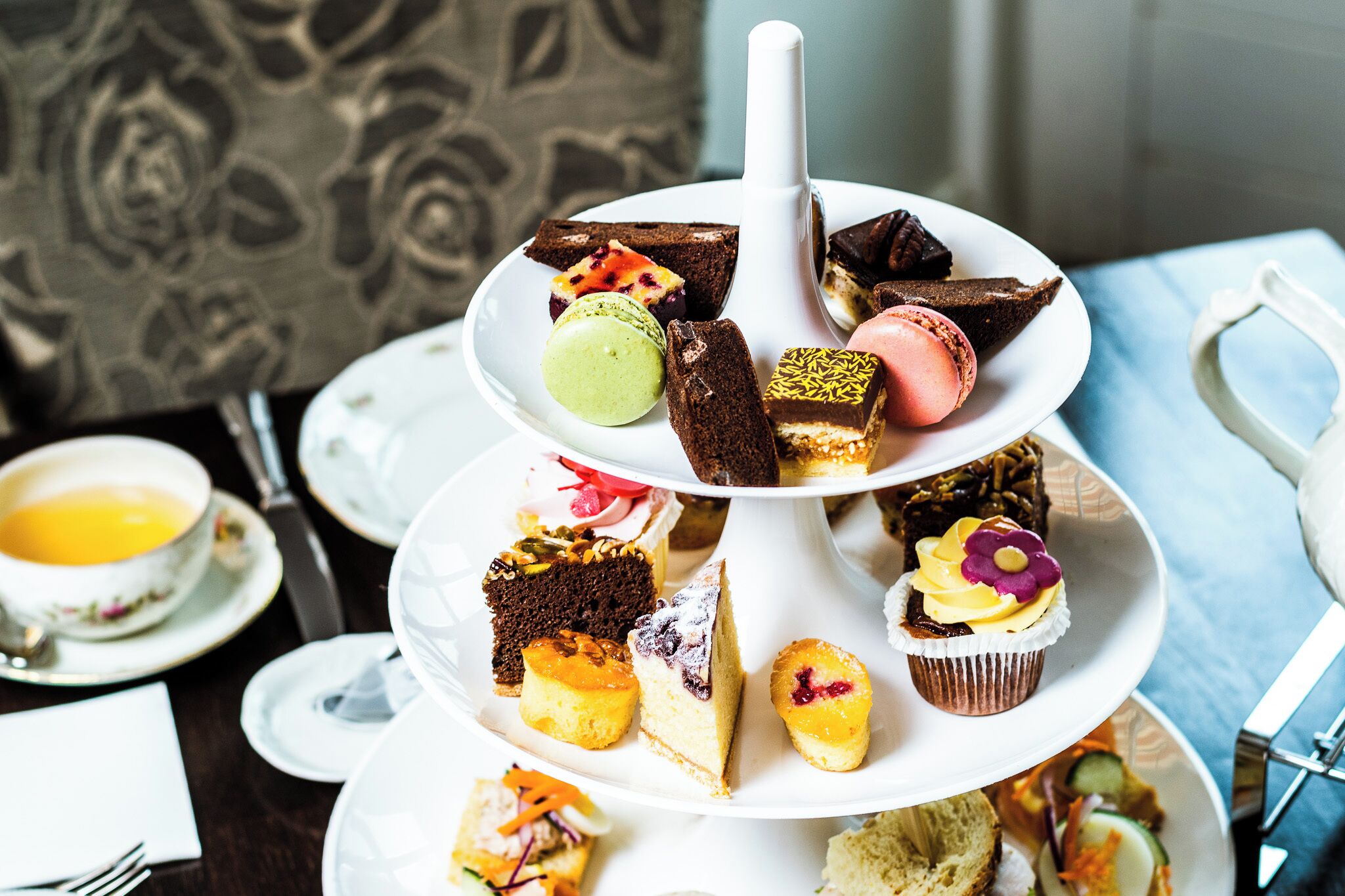 A multi-tiered dessert display with various pastries and cakes.