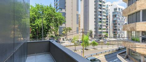 A high-rise building with a modern architectural design, featuring multiple floors and balconies.