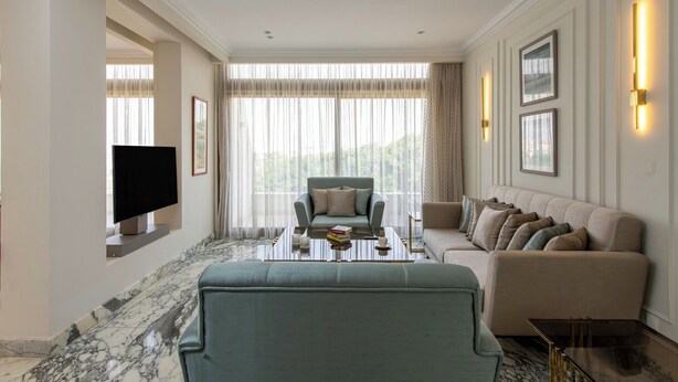 A modern living room with a sofa, a coffee table, and a TV. - Kennah Golfview Duplex 504 | Golf Estate, New Cairo (New Cairo)